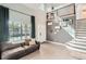 Spacious living area with high ceilings, modern decor, and an open staircase, creating a bright and inviting atmosphere at 3805 E 106Th Ave, Thornton, CO 80233