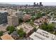 Aerial view showcasing the neighborhood with the city skyline and mountains in the background at 790 N Clarkson St # 206, Denver, CO 80218