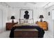 Well-lit bedroom with stylish lamps, decorative chests, and a comfortable bed with patterned bedding at 790 N Clarkson St # 206, Denver, CO 80218