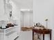 Hallway featuring white walls, hardwood floors, and decorative tables with lamps and decor at 790 N Clarkson St # 206, Denver, CO 80218
