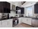 Modern kitchen boasts sleek black and white cabinets, stainless steel appliances, and lots of light at 790 N Clarkson St # 206, Denver, CO 80218