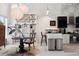 Modern kitchen features a dining area, stainless steel appliances, white and dark cabinetry, and unique lighting at 790 N Clarkson St # 206, Denver, CO 80218