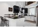 Modern kitchen features a breakfast bar, stainless steel appliances, white and dark cabinetry, and modern decor at 790 N Clarkson St # 206, Denver, CO 80218