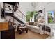 Stylish living room with modern staircase, comfortable seating, large windows, and unique decor at 790 N Clarkson St # 206, Denver, CO 80218