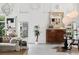 Minimalist living area featuring white walls, artistic decor, seating, and lots of natural light at 790 N Clarkson St # 206, Denver, CO 80218