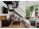 Bright living room featuring modern staircase, comfortable seating, large windows, and unique decor at 790 N Clarkson St # 206, Denver, CO 80218