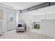 Bright open living space with a comfortable chair, modern railing, and view of the outdoors at 790 N Clarkson St # 206, Denver, CO 80218