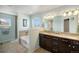 Relaxing bathroom with a tub and shower combo, dual sink vanity, and neutral tones, ideal for unwinding at 5475 Shoshone Dr, Longmont, CO 80504
