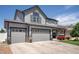 View of home's exterior with well-maintained lawn and three-car garage at 5475 Shoshone Dr, Longmont, CO 80504