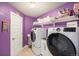Well-equipped laundry room with a washer, dryer, storage shelves, and a bright, clean aesthetic at 5475 Shoshone Dr, Longmont, CO 80504