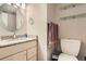 Cozy bathroom with vanity, round mirror, and toilet with visible storage at 2896 W 119Th Ave, Westminster, CO 80234