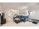 Comfortable living room featuring a plush blue sofa, neutral walls, and a staircase to the upper level at 2896 W 119Th Ave, Westminster, CO 80234