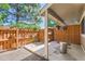 Cozy covered patio with wooden fencing, hanging flower baskets, and a peaceful ambiance at 2896 W 119Th Ave, Westminster, CO 80234