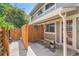 Private patio area with wooden fencing and hanging flower baskets for a serene outdoor retreat at 2896 W 119Th Ave, Westminster, CO 80234