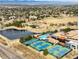 Aerial view showcasing community amenities, including a pool, tennis courts, and a clubhouse at 7033 E Lake Cir, Centennial, CO 80111