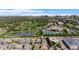 Aerial view of a neighborhood with mature trees, a park, a pond and other amenities, all near the city at 7033 E Lake Cir, Centennial, CO 80111