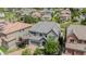 Gorgeous aerial view of a stone-accented home with lush landscaping and a grey tile roof in a lovely neighborhood at 7033 E Lake Cir, Centennial, CO 80111