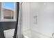 Bright bathroom features white subway tile in tub/shower combination with a window at 7033 E Lake Cir, Centennial, CO 80111