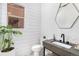 Modern powder room showcasing stylish finishes, including shiplap and a geometric mirror at 7033 E Lake Cir, Centennial, CO 80111