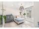 Cozy bedroom features a decorative armoire, layered chandelier, and a large window at 7033 E Lake Cir, Centennial, CO 80111