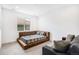 Spacious bedroom features platform bed and large window for abundant natural light at 7033 E Lake Cir, Centennial, CO 80111