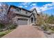 Charming two-story home boasts a brick driveway, stone accents, and a two-car garage at 7033 E Lake Cir, Centennial, CO 80111
