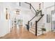 Bright foyer with hardwood floors, a grand staircase, and elegant lighting at 7033 E Lake Cir, Centennial, CO 80111
