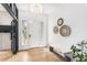 Spacious entry features a bench, modern light fixture, and light hardwood flooring at 7033 E Lake Cir, Centennial, CO 80111
