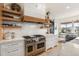 Well-appointed kitchen featuring a professional-grade Wolf range and custom cabinetry at 7033 E Lake Cir, Centennial, CO 80111