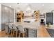 Stylish kitchen with an oversized island, pendant lights, and open shelving at 7033 E Lake Cir, Centennial, CO 80111