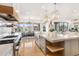 Open kitchen with large island, eat-in dining, and seamless flow into the living area at 7033 E Lake Cir, Centennial, CO 80111