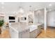 Large kitchen island with seating, farmhouse sink, and open layout to the living room at 7033 E Lake Cir, Centennial, CO 80111