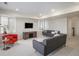 A well-lit living room showcases modern furniture, neutral tones, and a mounted TV for relaxed entertainment at 7033 E Lake Cir, Centennial, CO 80111