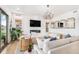 Beautiful living room featuring a modern fireplace, chandelier, and hardwood floors at 7033 E Lake Cir, Centennial, CO 80111