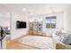 Comfortable living room features a cream sofa, decorative shelving and a large window at 7033 E Lake Cir, Centennial, CO 80111