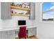 Cozy home office with built-in shelving and a comfortable workspace with natural light at 7033 E Lake Cir, Centennial, CO 80111