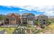 Beautiful rear yard with tiered landscaping, patio, and stone accents on a modern home at 7033 E Lake Cir, Centennial, CO 80111