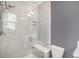Walk-in shower with subway tile, glass door, shower bench, and chrome shower head at 7033 E Lake Cir, Centennial, CO 80111
