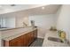 A granite countertop bar features a wood base cabinet, a sink, and ample counter space at 7033 E Lake Cir, Centennial, CO 80111