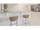 Stylish bar area featuring a speckled stone countertop, wicker seating, and an open layout at 7033 E Lake Cir, Centennial, CO 80111
