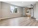 Finished basement with wood floors, a large window and a doorway leading to another room at 7778 Windwood Way, Parker, CO 80134