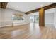 Finished basement area with wood beams, columns and natural light, and wood floor at 7778 Windwood Way, Parker, CO 80134