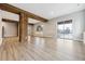 Finished basement area with wood beams and columns, lots of natural light, and wood floor at 7778 Windwood Way, Parker, CO 80134