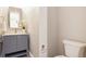 This bathroom features a marble countertop, gold fixtures, and a toilet at 7778 Windwood Way, Parker, CO 80134