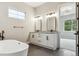 Bathroom boasts double vanity, freestanding tub, modern fixtures, and natural light at 7778 Windwood Way, Parker, CO 80134