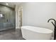 Bathroom with free-standing tub, open shower, and modern fixtures at 7778 Windwood Way, Parker, CO 80134