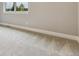 The primary bedroom has plush carpet, a window with natural light, and neutral paint at 7778 Windwood Way, Parker, CO 80134