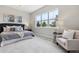 Bright and inviting bedroom featuring plush carpet and a chair for relaxation at 7778 Windwood Way, Parker, CO 80134