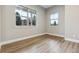 Cozy bedroom features hardwood floors and two large windows offering an abundance of natural light at 7778 Windwood Way, Parker, CO 80134