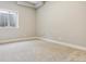 Well-lit bedroom with neutral carpeting, showcasing a clean and comfortable atmosphere at 7778 Windwood Way, Parker, CO 80134